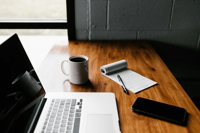 Laptop and coffee on table top